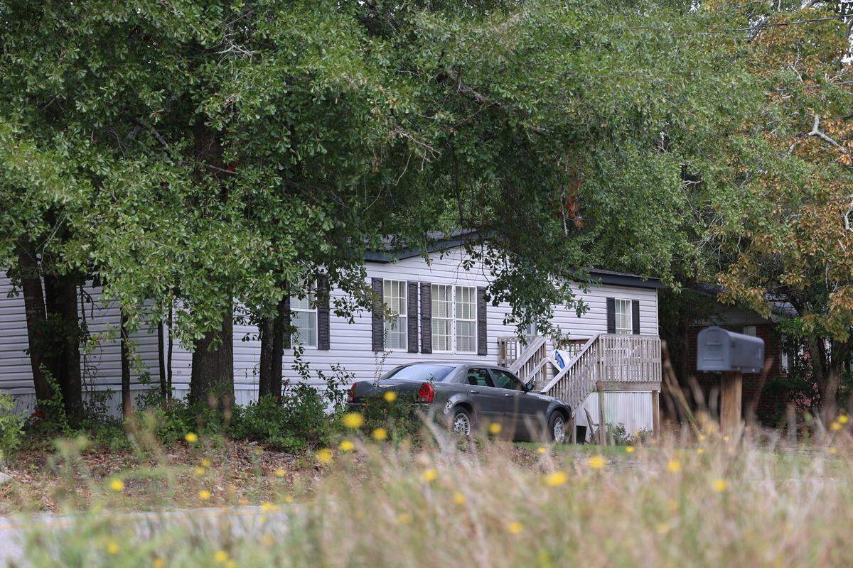 Demetris Summers spent most of his high school years living at his grandmother’s house on George Street in Lexington. Photographed on Oct. 10, 2025, a mature elm tree shades a modern trailer that was moved to the lot in the 1990s after the original home burned down.