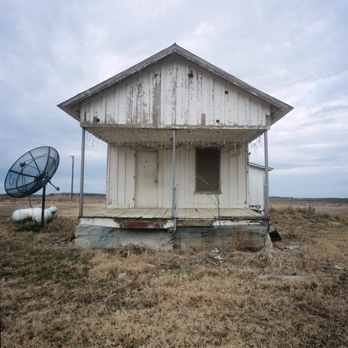 Mississippi Delta lifestyles have not, of course, remained completely in the past but have adapted some of the technologies of urban and suburban lifestyles. Robbins’ “Shotgun House” presents one example of the juxtapositions of farm traditions with new methods.