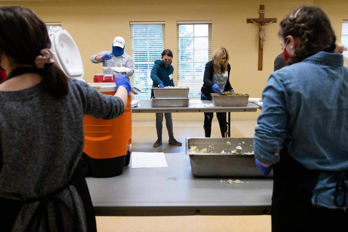 Members of churches across Columbia prepare a Thanksgiving lunch at The Basilica of St. Peter in downtown Columbia, South Carolina on Thursday, November 26, 2020. The boxed lunch contained turkey, green beans, dressing, mashed potatoes and gravy.