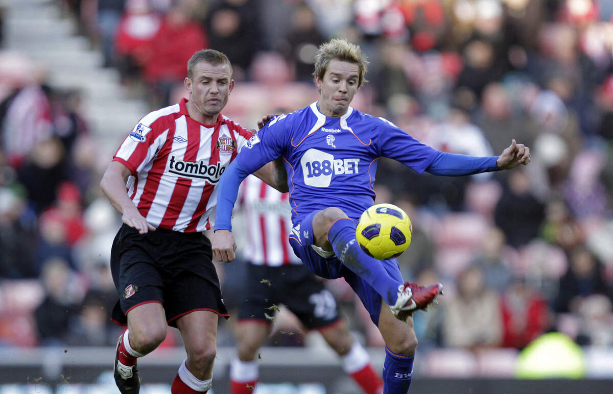 Stu Holden (right), pictured here 2010, played professionally in the English Premier League and Major League Soccer.