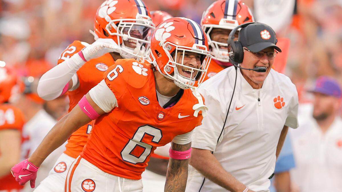 Clemson safety Ricardo Jones (6) and defensive coordinator Tom Allen celebrate Jones' interception against SMU in Clemson, S.C on Saturday, Oct. 18, 2025.