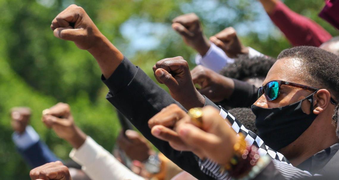 People celebrate on the South Carolina State House steps during the Million Man March in Columbia. Participants marched from Martin Luther King Park to the State House. 6/14/20