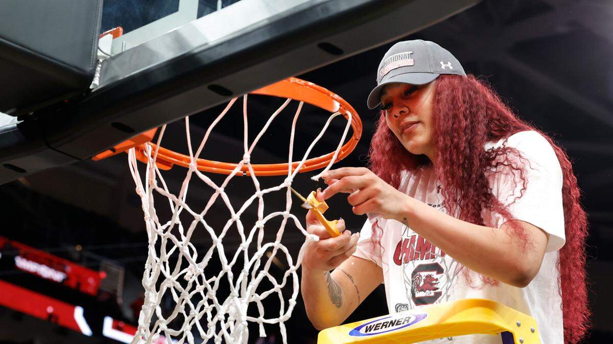 South Carolina’s Kamilla Cardoso (10) cuts a piece of the net after winning the National Championship after beating Iowa at the Rocket Mortgage FieldHouse in Cleveland, Ohio on Sunday April 7, 2024.