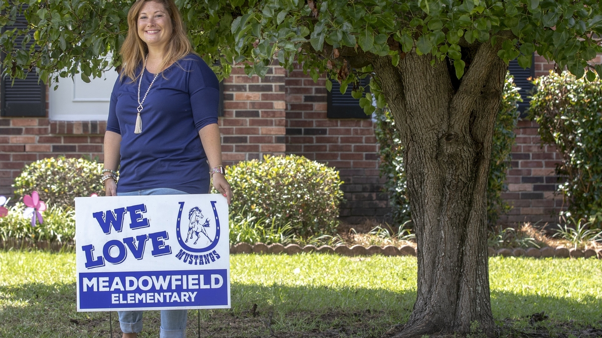 Anna Moore, PTO president for Meadowfield Elementary off Garners Ferry Road, shows off her school pride with a sign posted in her home’s front yard.