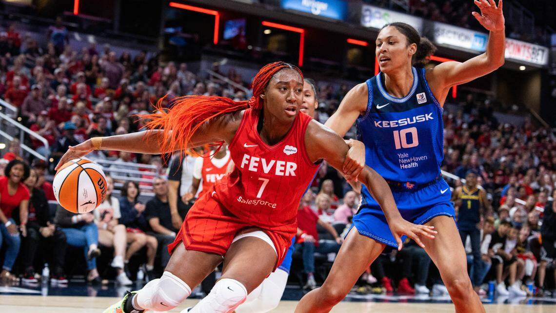 May 19, 2023; Indianapolis, Indiana, USA; Indiana Fever forward Aliyah Boston (7) dribbles the ball while Connecticut Sun center Olivia Nelson-Ododa (10) defends in the second half at Gainbridge Fieldhouse. Mandatory Credit: Trevor Ruszkowski-USA TODAY Sports