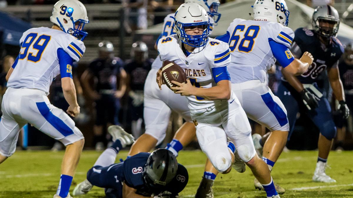Lexington Wildcats quarterback Cal Herndon (4) scrambles during the game between Lexington High School at White Knoll High School.