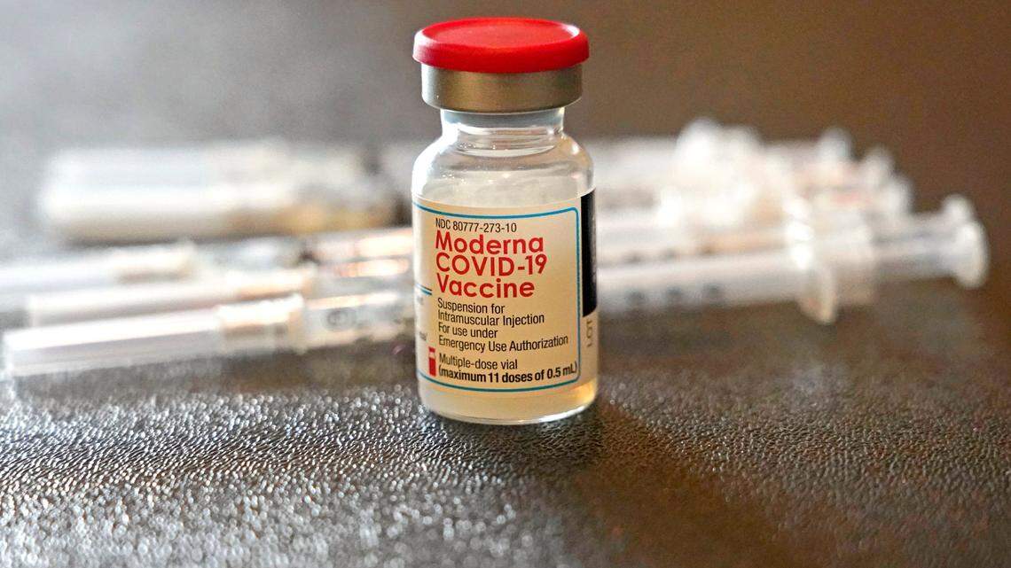 A vial filled with the Moderna COVID-19 vaccine rests by syringes waiting to be loaded by nurses from the Jackson-Hinds Comprehensive Health Center, at a vaccination station next to Jackson State University in Jackson, Miss., on Dec. 7, 2021.