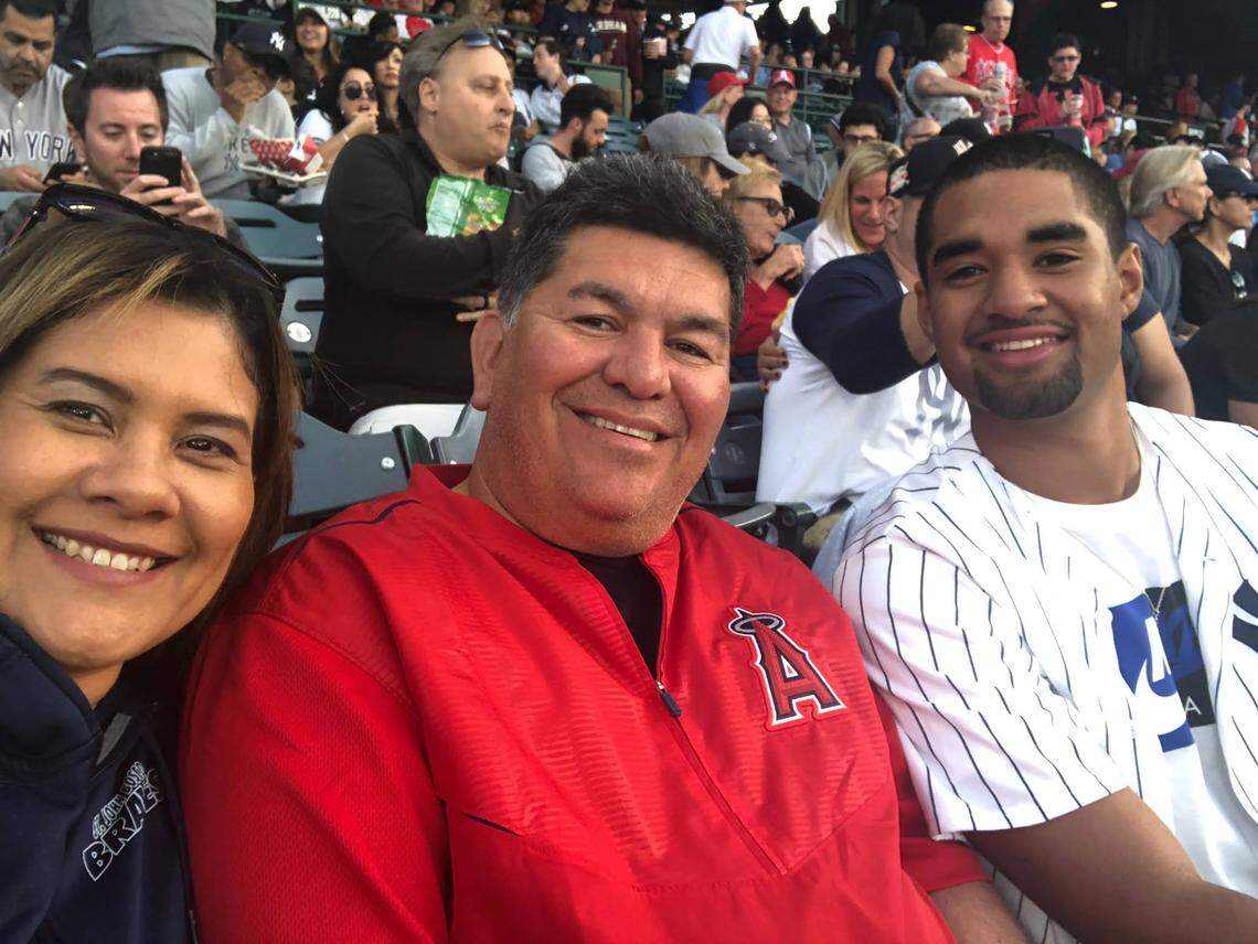 D.J. Uiagalelei (right) attends a Los Angeles Angels baseball game with Paul Diaz and his wife, Sandra.