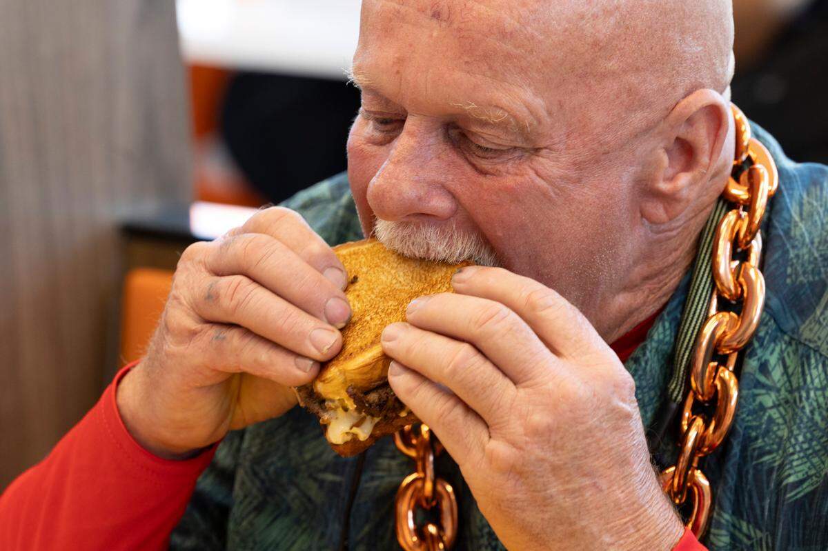 Phil Foust enjoys a Whataburger patty melt during the grand opening of the Whataburger in Irmo, South Carolina, in September. Foust got in line at 12:40 p.m. on Sunday to be the first in line when the restaurant opened.