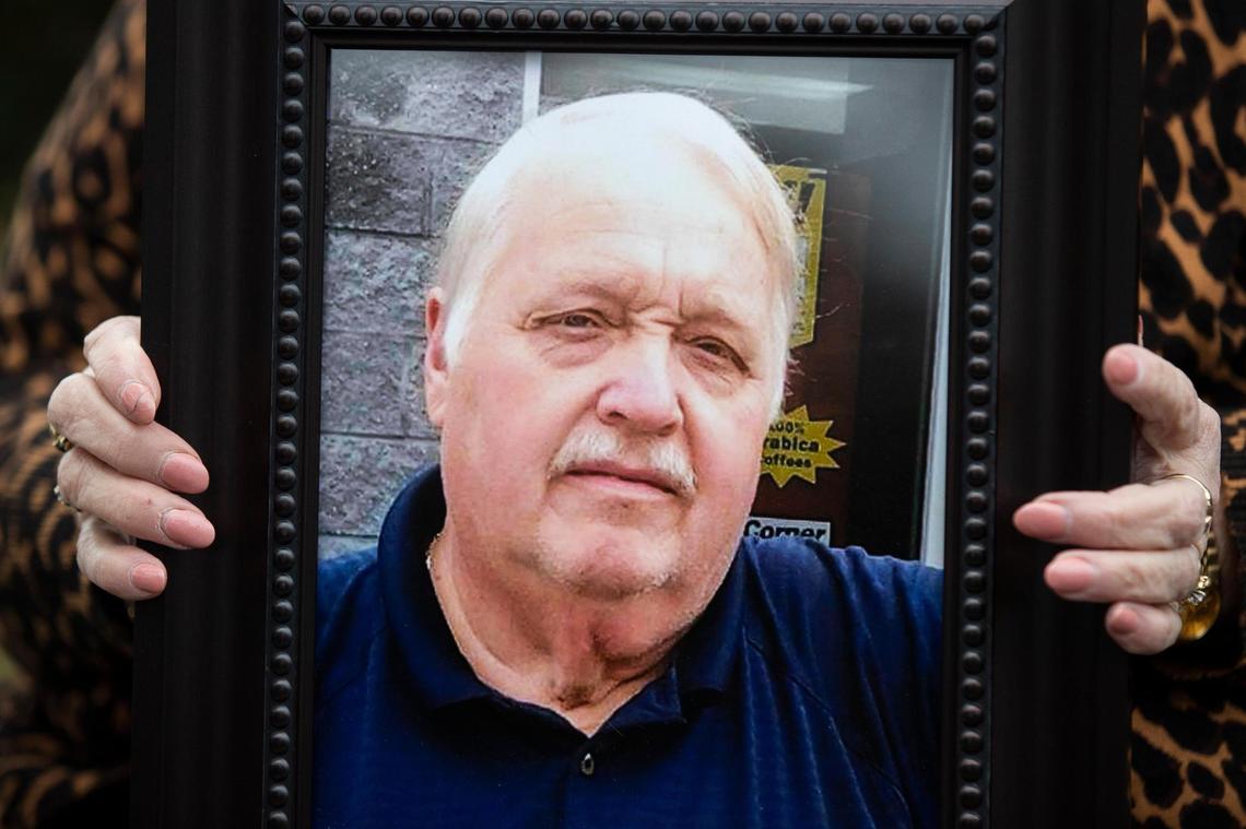 Karen Lovette poses for a portrait holding a photograph of her husband Al Lovette in Camden, South Carolina on Tuesday, March 2, 2021. Al died from the coronavirus. They were married for 40 years.