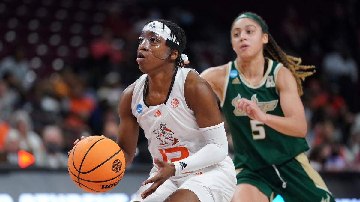 Miami guard Lashae Dwyer (13) dribbles the ball ahead of South Florida guard Elena Tsineke (5) during the first half a first-round game in the NCAA women’s college basketball tournament, Friday, March 18, 2022, in Columbia, S.C. (AP Photo/Sean Rayford)
