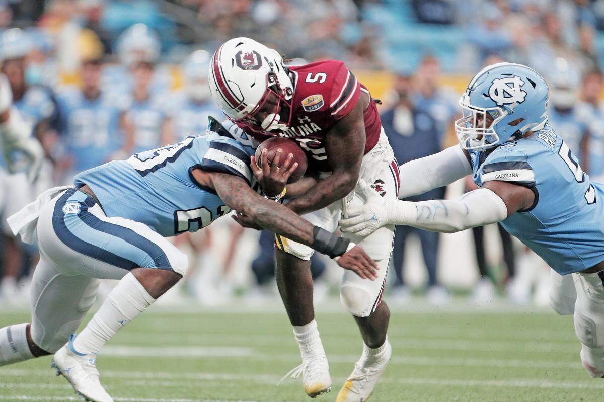 South Carolina quarterback Dakereon Joyner (5) is tackled at the Duke’s Mayo Bowl at Bank of America Stadium in Charlotte on Dec. 30, 2021. 