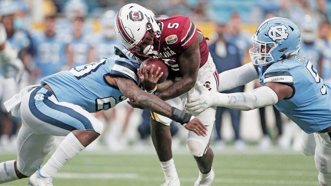 South Carolina Gamecocks wide receiver Dakereon Joyner (5) is tackled by North Carolina’s Power Echols 23 and Jahvaree Ritzie 5 at the Duke’s Mayo Bowl at Bank of America Stadium in Charlotte, North Carolina on Thursday, December 30, 2021.