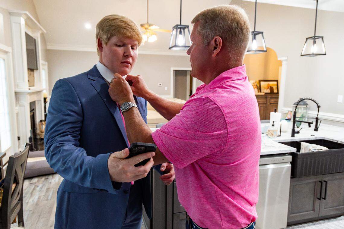 Cameron Turner gets help with his tie from his father, William.