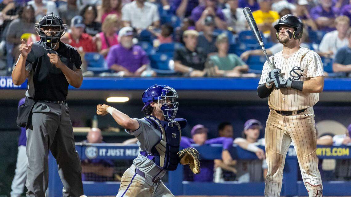 South Carolina Gamecocks catcher Cole Messina (19) reacts to a strike call as LSU Tigers catcher Alex Milazzo (7) returns the ball to the pitcher during the SEC Baseball Tournament at Hoover Metropolitan Stadium.