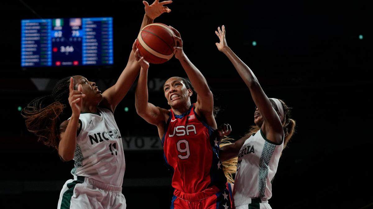 United States’ A’Ja Wilson (9), center, grabs a rebound between Nigeria’s Adaora Elonu (11), left, and Atonye Nyingifa (21) during women’s basketball preliminary round game at the 2020 Summer Olympics, Tuesday, July 27, 2021, in Saitama, Japan. (AP Photo/Eric Gay)