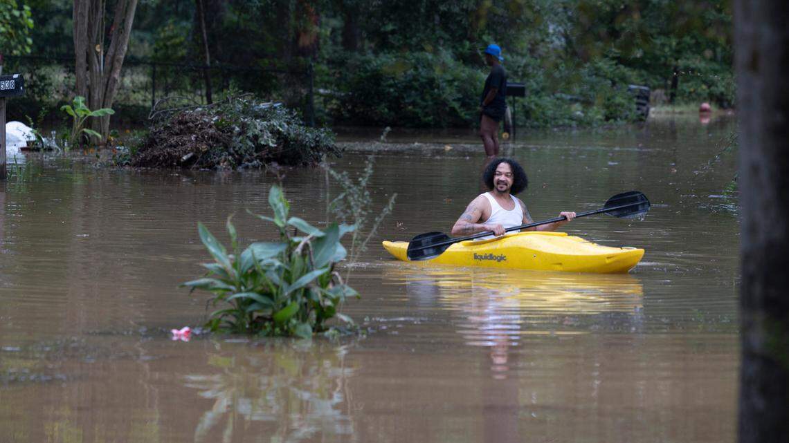William Marshall plays in the floodwater on Hudson Avenue as the nearby Congaree River creep into the Riverland Park subdivision in Cayce on Sunday, Sept 29, 2024. Marshall said he kayaked in the same runoff when Hurricane Hugo came through.