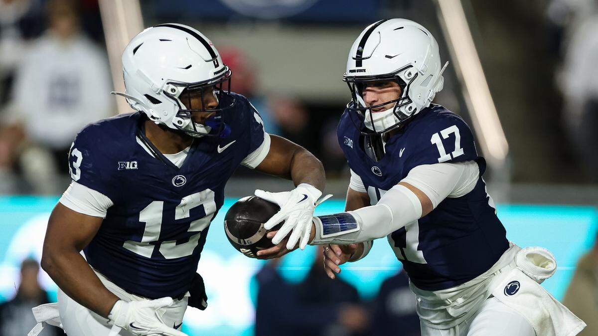 STATE COLLEGE, PA - NOVEMBER 22: Ethan Grunkemeyer #17 of the Penn State Nittany Lions hands the ball off to Kaytron Allen #13 during the first half against the Nebraska Cornhuskers at West Shore Home Field at Beaver Stadium on November 22, 2025 in State College, Pennsylvania. (Photo by Scott Taetsch/Getty Images)