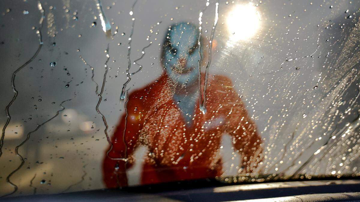 A scary ghoul is seen through water on a windshield at Hurricane Express Wash. The car washes are offering a haunted car wash experience through Halloween.