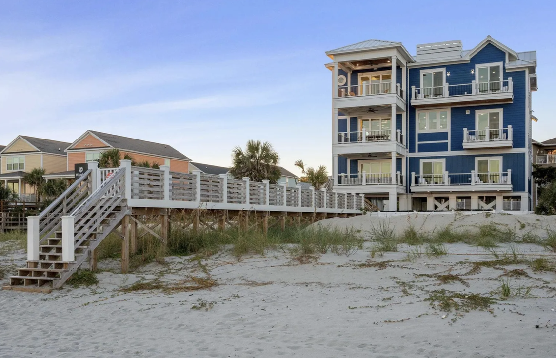 A walkway across the dunes provides access to the beach.