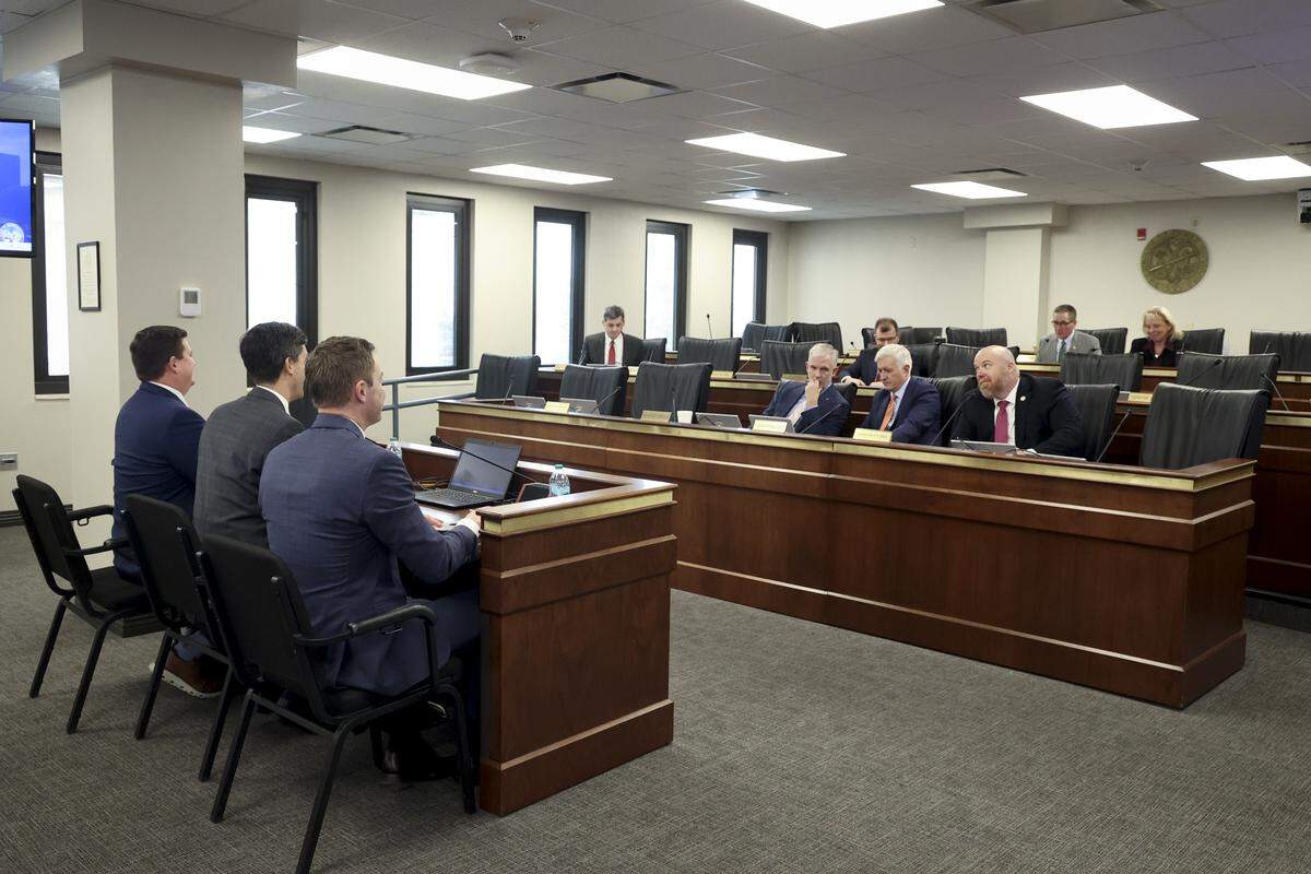 From left, Coastal Carolina Athletic Director Chance Miller, Clemson Athletic Director  Graham Neff, and South Carolina Athletic Director Jeremiah Donati,  participate in a meeting of the Senate Education Committee on Wednesday, Feb. 25, 2026.