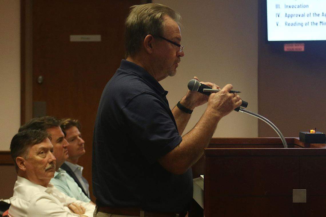 A resident lists concerns with the proposed Water Walk project at an Irmo Town Council meeting as developers look on Tuesday, Sept. 17, 2024.