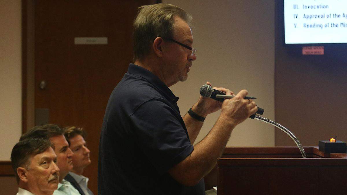 A resident lists concerns with the proposed Water Walk project at an Irmo Town Council meeting as developers look on Tuesday, Sept. 17, 2024.