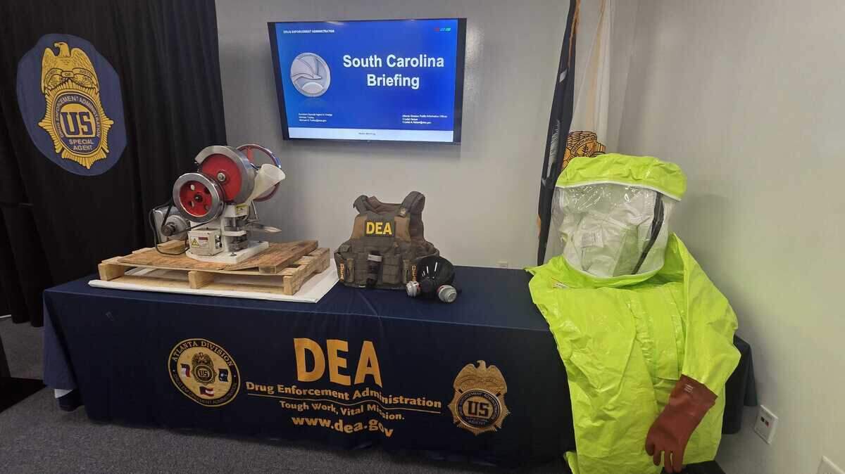 DEA South Carolina displays a pill press, bullet proof vest, gas mask and hazmat suit during a media briefing on Sept. 17, 2025.