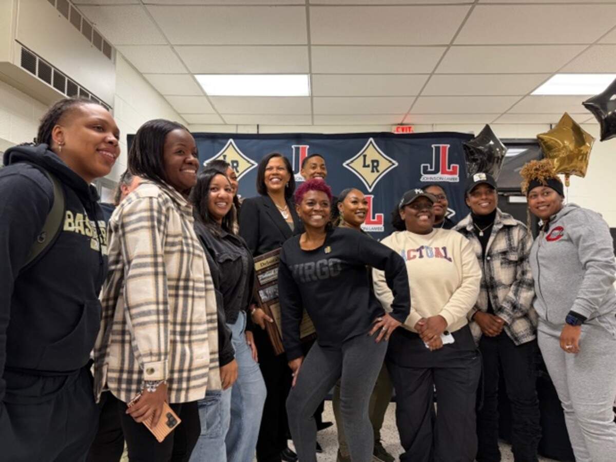Former Lower Richland girls basketball coach Deborah (Stroman) Wardlaw poses for a photo with former players and coaches after the school named the court in her honor on Feb. 4, 2026.