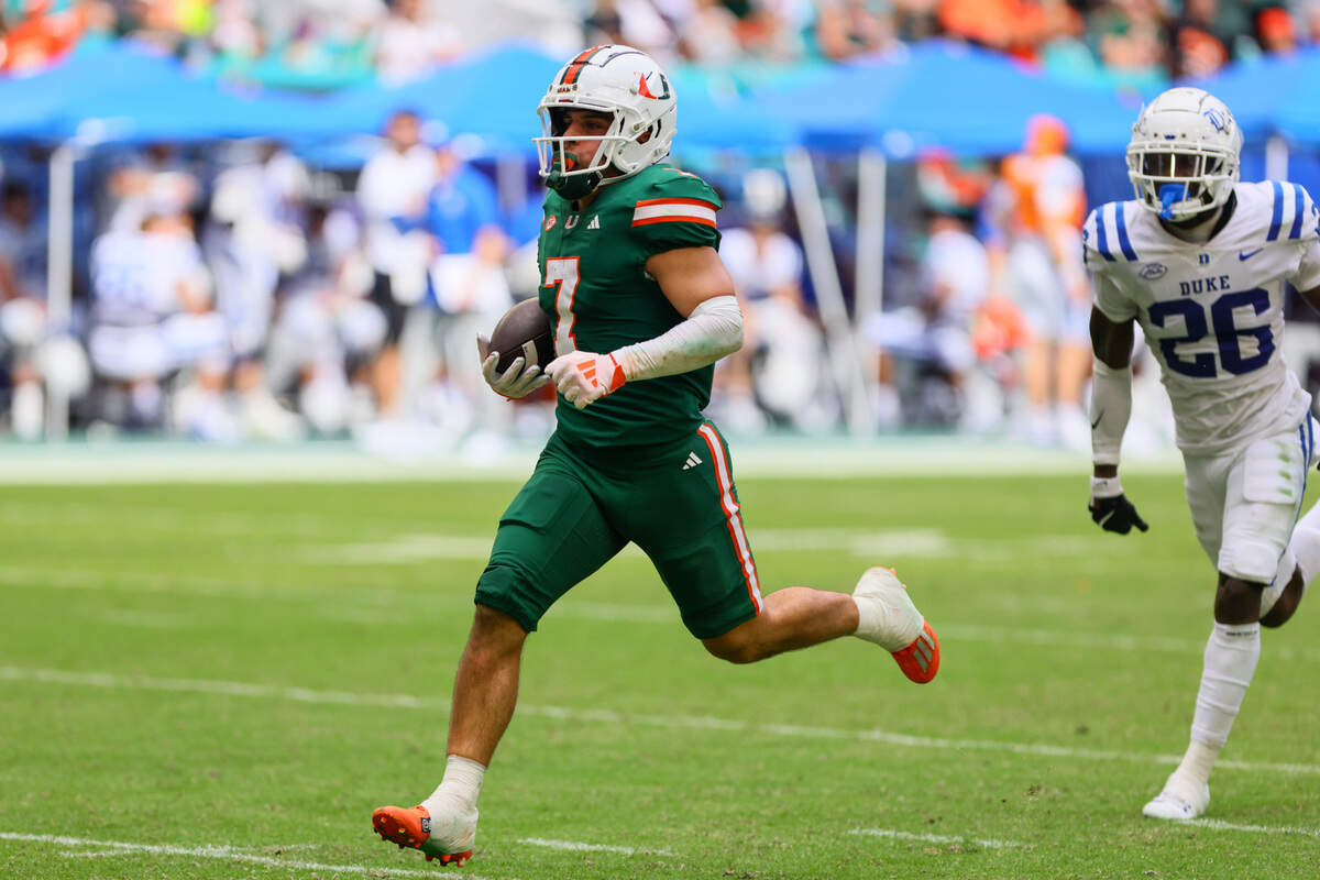 Nov 2, 2024; Miami Gardens, Florida, USA; Miami Hurricanes wide receiver Xavier Restrepo (7) runs with the football for a touchdown against the Duke Blue Devils during the fourth quarter at Hard Rock Stadium.