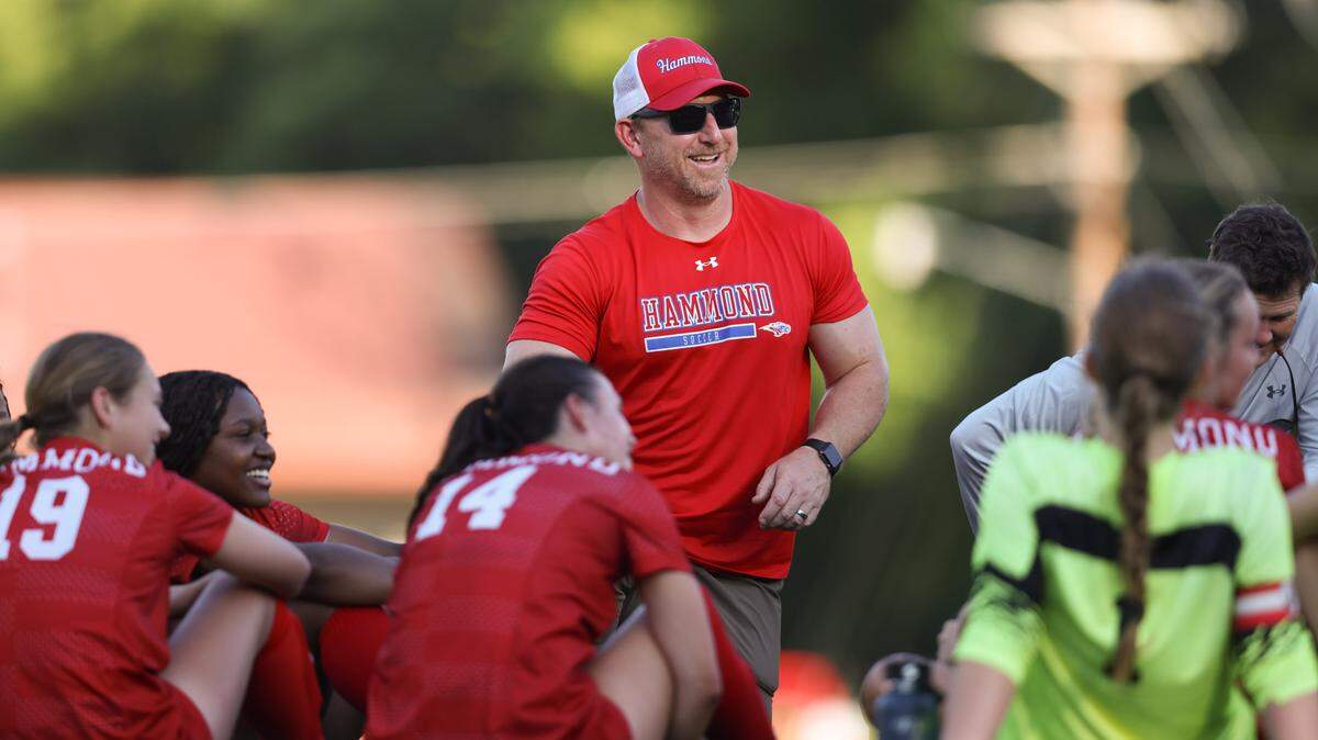 Head coach Ryan Brewer of Hammond laughs with his players during halftime of Hammond’s match against Hilton Head Christian in Columbia on Tuesday, May 6, 2025.