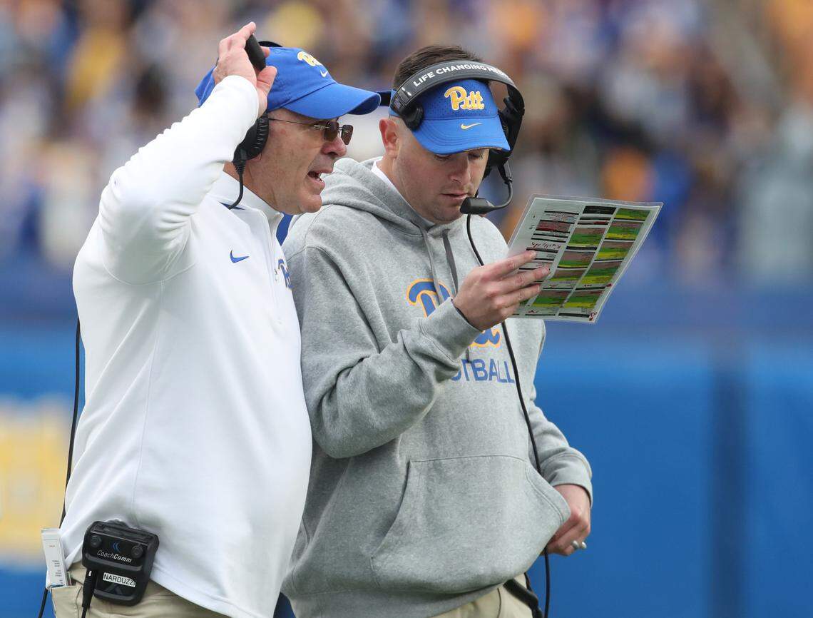 Nov 16, 2024; Pittsburgh, Pennsylvania, USA; Pittsburgh Panthers head coach Pat Narduzzi (left) and offensive coordinator Cade Bell (right) talk on the field against the Clemson Tigers during the fourth quarter at Acrisure Stadium.