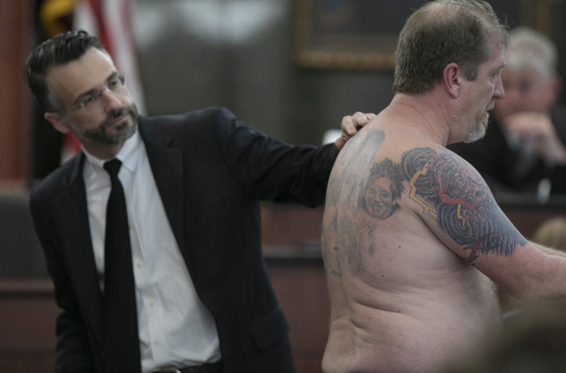 Defense attorney Casey Secor points out the tattoos Tim Jones Sr. he has gotten on his back since the grandchildren were killed in 2014, during the sentencing phase of the trial of his son, Tim Jones in Lexington. Timothy Jones, Jr. was found guilty of killing his 5 young children in 2014. 6/10/19