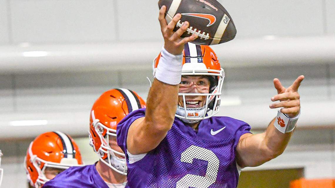 Clemson quarterback Cade Klubnik (2) smiles warming up during the Tigers' first preseason practice Thursday.