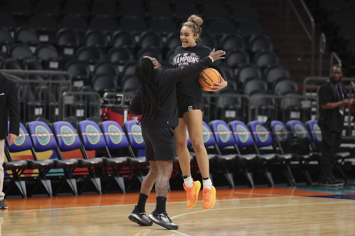 South Carolina's Tessa Johnson (5) and South Carolina's assistant coach Khadijah Sessions celebrate during practice at Mortgage Matchup Center in Phoenix on Thursday, April 2, 2026.