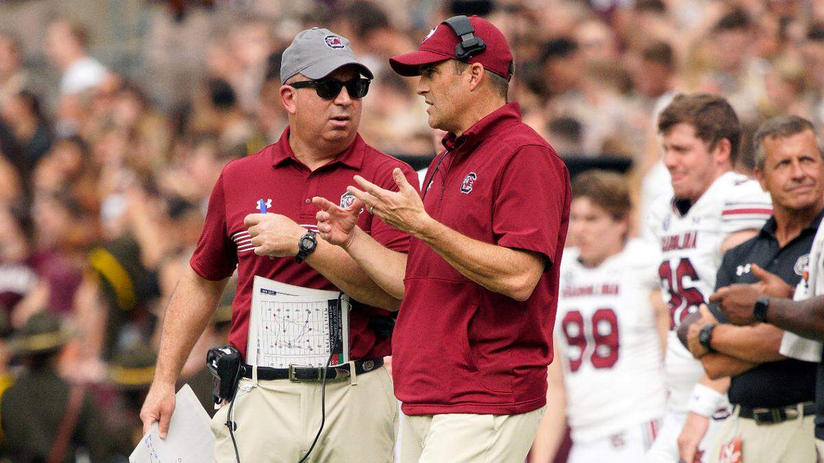 South Carolina Gamecocks head coach Shane Beamer and assistant coach Pete Lembo on the sideline during their October 2023 game against Texas A&M at Kyle Field.