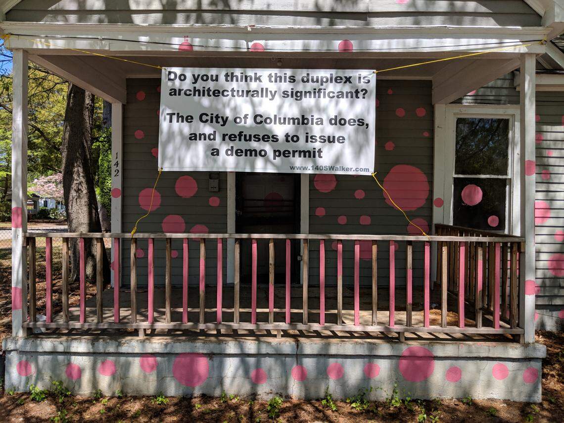 A Columbia builder is protesting the city decsion to not issue a demolition permit for this duplex in Shandon with polka dots and signs.