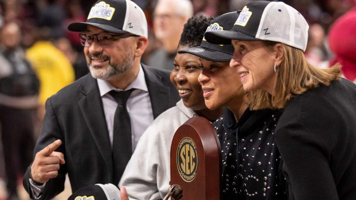 South Carolina Gamecocks head coach Dawn Staley poses with the SEC trophy following South Carolina’s game against the visiting Bulldogs at Colonial Life Arena in Columbia on Sunday, February 26, 2023.