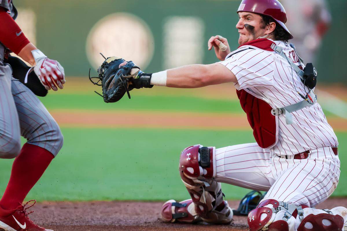South Carolina Gamecocks catcher Talmadge LeCroy (5) attempts to tag out Oklahoma Sooners infielder Jaxon Willits (7) during their game at Founders Park, 3/14/25.