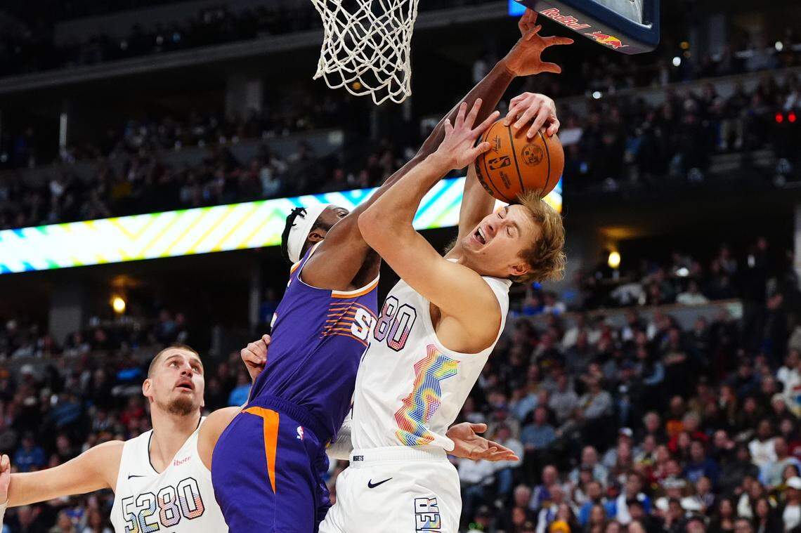 Phoenix Suns forward Josh Okogie (2) and Denver Nuggets forward Hunter Tyson (5) reach for a rebound in the second quarter at Ball Arena.