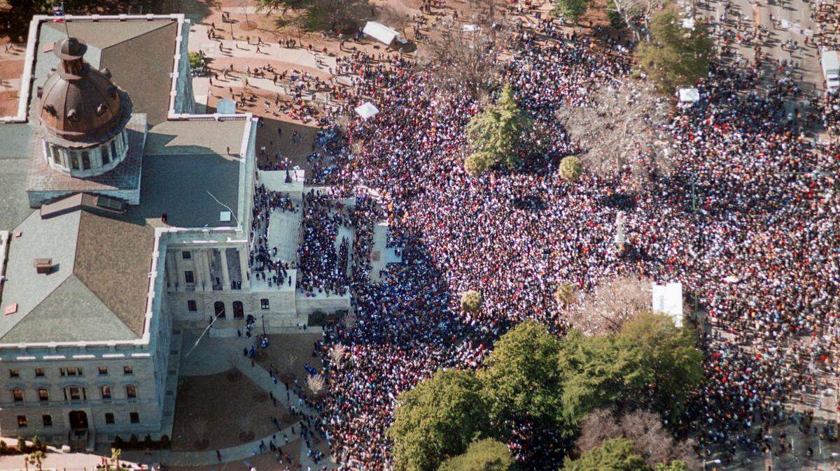 An estimated 46,000 people marched in downtown Columbia, SC Monday (1/17/2000) protesting the flying of the Confederate flag atop the State House dome. The march and rally, commemorating the life and work of the late Rev. Martin Luther King Jr. , was without any major incidents. The flag has been flying since 1962 when the S.C Legislature raised the flag to celebrate the Civil War centennial. This march is also apparently the one of the largest in South Carolina history. ERIK CAMPOS/THE STATE