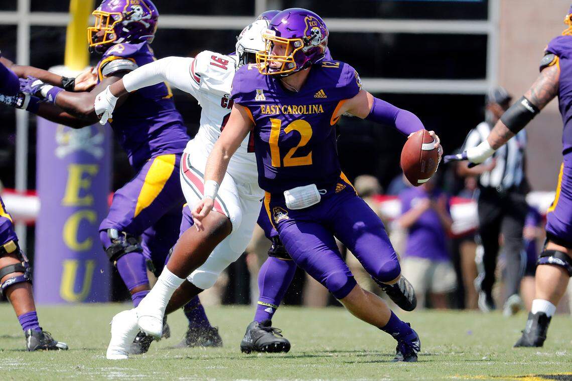 East Carolina’s Holton Ahlers (12) runs away from South Carolina’s Tonka Hemingway (91) during the first half of an NCAA college football game in Greenville, N.C., Saturday, Sept. 11, 2021. (AP Photo/Karl B DeBlaker)