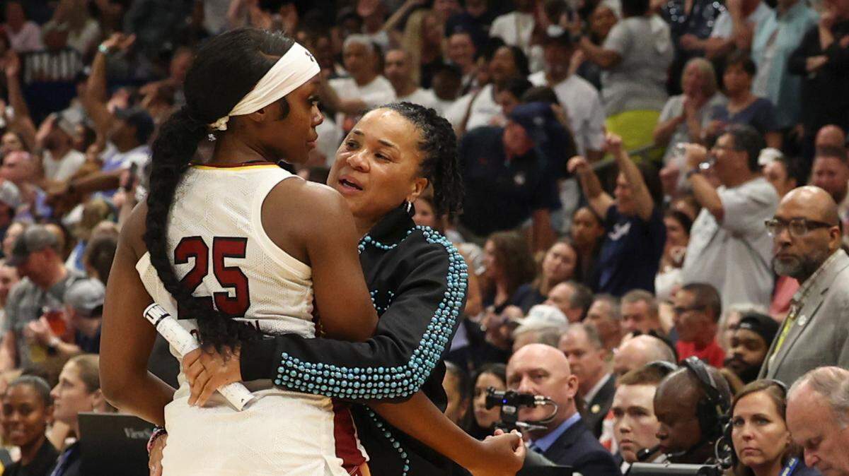 University of South Carolina’s Raven Johnson (25) embraces University of South Carolina Head Coach Dawn Staley as she leaves the court for the last time during the second half of action against the University of Connecticut for the NCAA National Championship at Amalie Arena in Tampa, Fla. on Sunday, April 6, 2025.