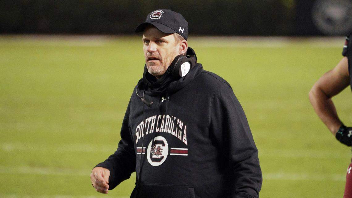South Carolina interim head coach Mike Bobo walks down the sideline near South Carolina tight end Nick Muse (9) during the second half of an NCAA college football game against Missouri Saturday, Nov. 21, 2020, in Columbia, S.C. Missouri won 17-10. (AP Photo/Sean Rayford)