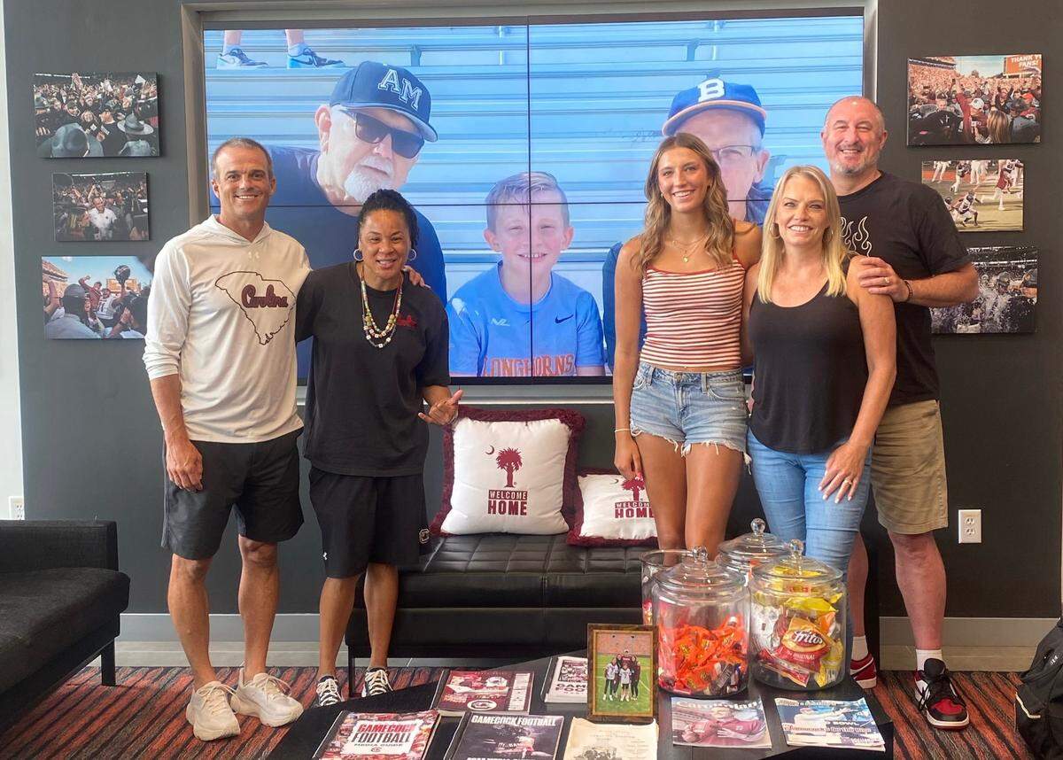 Top WBB recruit McKenna Woliczko with South Carolina football head coach Shane Beamer and Gamecock women’s basketball head coach Dawn Staley along with her parents during her official visit in July 2025.
