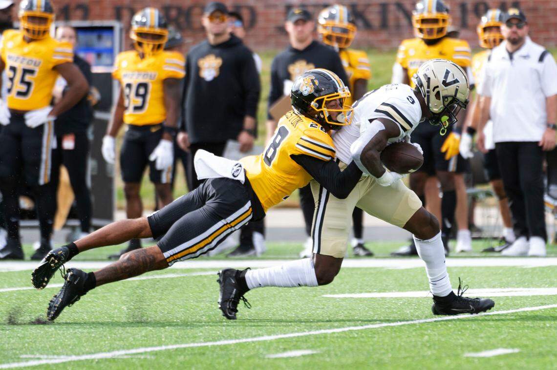 Missouri defensive back Joseph Charleston, left, tackles Vanderbilt wide receiver Quincy Skinner Jr., right, after a reception during the first quarter of an NCAA college football game Saturday, Oct. 22, 2022, in Columbia, Mo. (AP Photo/L.G. Patterson)