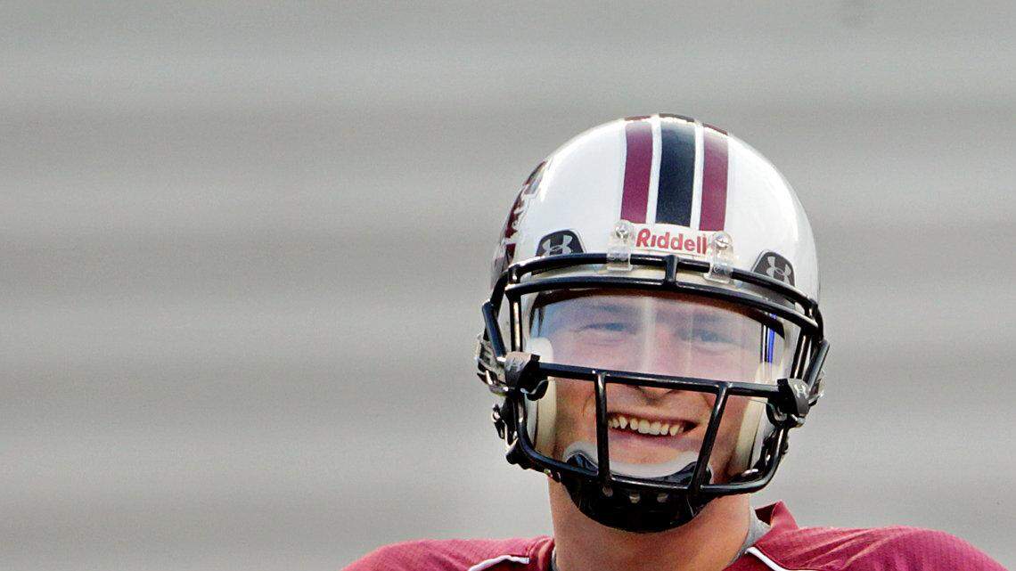 University of South Carolina quarterback Connor Shaw, left, and quarterbacks coach, G.A. Mangus, share a laugh as the Gamecocks prepare for their scrimmage at William-Brice Stadium.