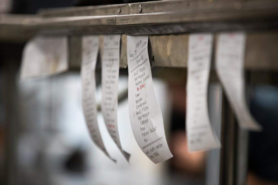 Tickets stack up at The Lizard Thicket on Elmwood Road in Columbia, South Carolina on Friday, August 27, 2021. Operations manager Matthew Williams says the restaurant currently has around half the employees it did before the coronavirus pandemic.