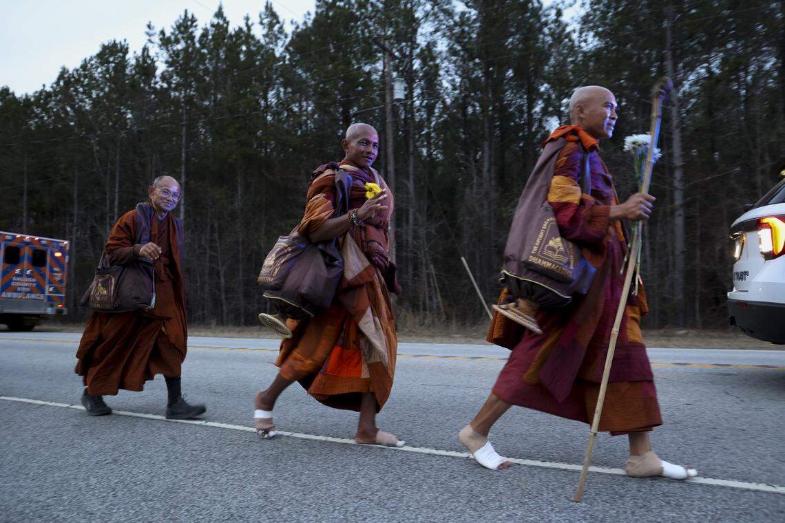 A group of Buddhist monks walk along U.S. 378 in Saluda County with the Walk for Peace on Thursday, Jan. 8, 2026. The group of Buddhist monks is walking 2,300 miles, from Fort Worth, Texas, to Washington, D.C., spreading a message of peacefulness.