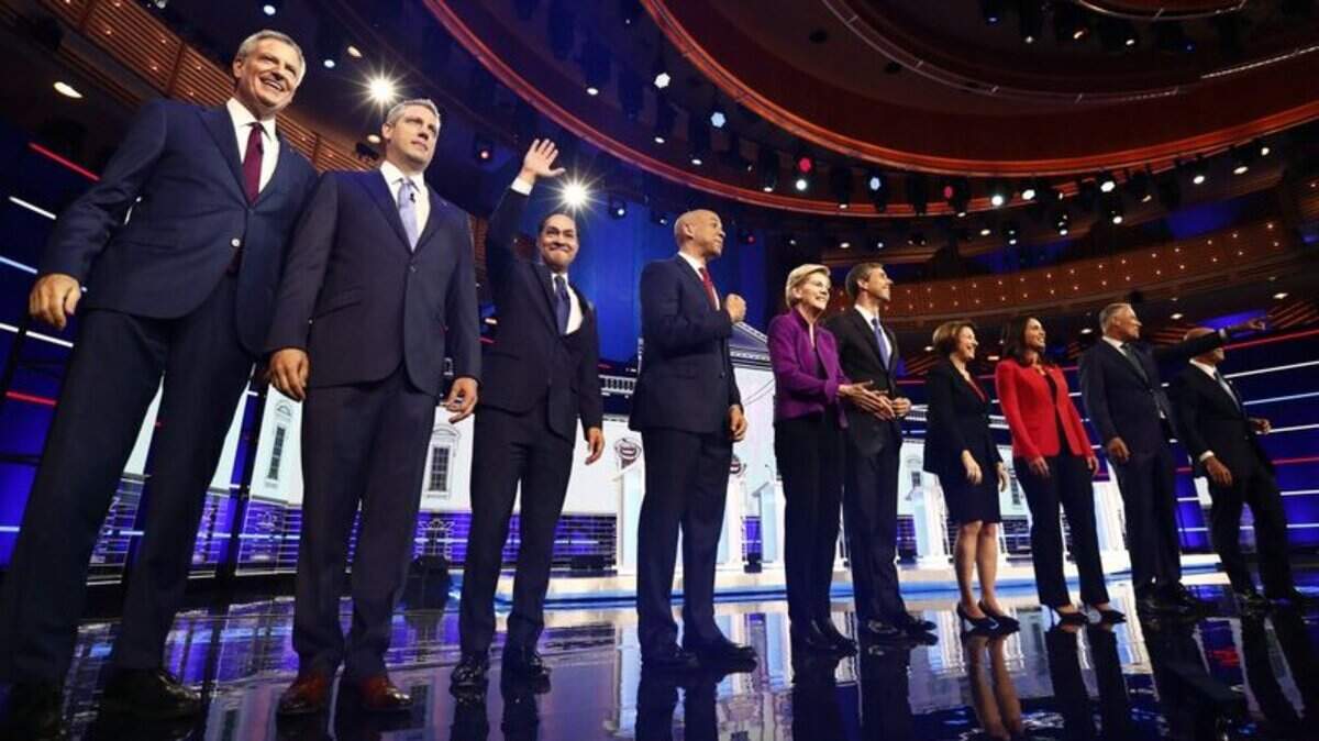 From left, New York City Mayor Bill de Blasio, Rep. Tim Ryan, D-Ohio, former Housing and Urban Development Secretary Julian Castro, Sen. Cory Booker, D-N.J., Sen. Elizabeth Warren, D-Mass., former Texas Rep. Beto O’Rourke, Sen. Amy Klobuchar, D-Minn., Rep. Tulsi Gabbard, D-Hawaii, Washington Gov. Jay Inslee, and former Maryland Rep. John Delaney pose for a photo on stage before the start of a Democratic primary debate hosted by NBC News at the Adrienne Arsht Center for the Performing Arts, Wednesday, June 26, 2019, in Miami.